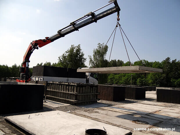 Załadunek szczelnego szamba betonowego do transportu  w Wołczynie